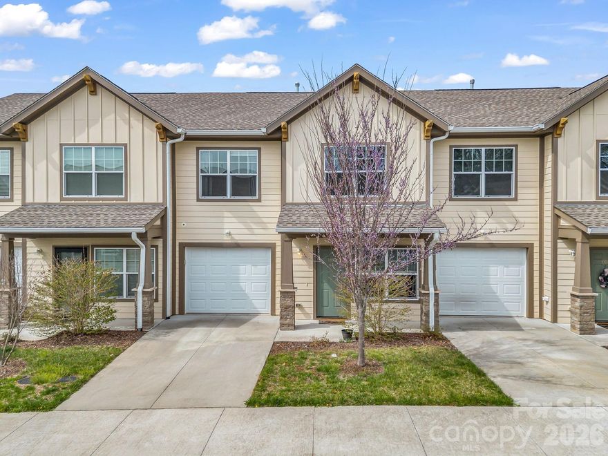 Turn-key and thoughtfully designed, this like-new townhome offers the perfect blend of comfort, style, and convenience. Built in 2020 and owned by one owner since construction, the home lives large with an open-concept layout ideal for everyday living and entertaining. The main level features prefinished wood floors, an upscale kitchen with stainless steel appliances, a highly sought-after natural gas range, and seamless flow into the living and dining areas.

Upstairs, you’ll find well-appointed bedrooms with cozy carpeting. Energy-efficient features, including an ENERGY STAR washer and a natural gas tankless water heater, add modern convenience and long-term value.

Enjoy a low-maintenance, fenced outdoor space with a mix of patio area for grilling and a small grassy section for pets or play. A one-car garage plus driveway parking provides room for two vehicles, with guest parking just two doors down.

Ideally located one street from the neighborhood playground and dog park, and just 8 minutes to Gerber Village and Asheville Airport, and 20 minutes to both Downtown Asheville and Downtown Hendersonville, this home offers low-maintenance living in a highly convenient location.