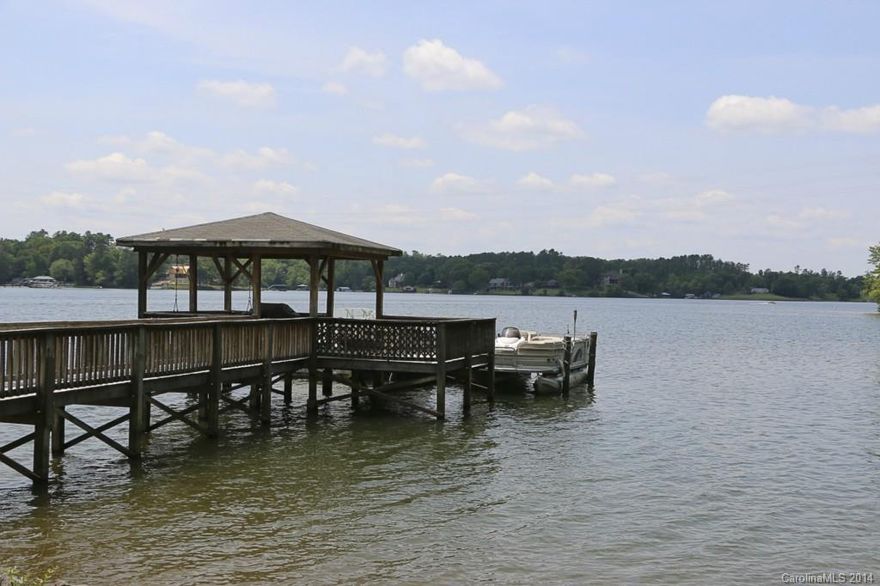 Wow, what a view! This is the level, big view lot you have been looking for, well suited for a "showplace" lake home. Over 330 ft of shoreline stabilized with beach area. Dock in place with covered seating area and floating slip. Mobile home on site that could be used until you are ready to build. Very private, spectacular property on Lake Wylie, 1.2 acres with plenty of room to build.  Property also listed as Residential, MLS #3148617. See tour!