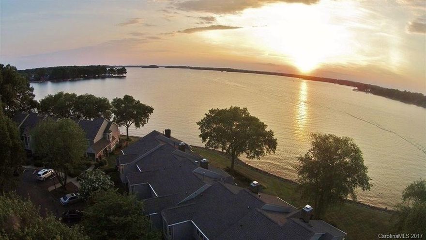 WATERFRONT Townhome on Lake Norman. Views year round. Relax on your Master bedroom Balcony or large patio off the main floor. There are many upgrades throughout, including granite, hard wood flooring, large walk-in pantry, and carpets. The home has a large loft or office space overlooking the amazing view of the water. Private gated subdivision with common areas to walk on the pier and enjoy a dip by the waterfront pool. Located within great schools, Lake Norman, Birkdale, & I-77