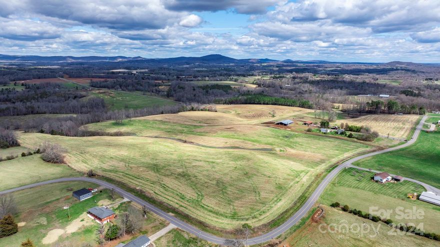 Embrace a rare opportunity with this 104+ acre farm, combining vast pastoral landscapes and practical agricultural facilities. With over 5000 feet of road frontage for easy access, the land is largely fenced and cleared, ideal for pasture or crops. It's enriched by two water sources, Bull Branch and Wallace Creek, enhancing its appeal for livestock or irrigation. Included is a charming farmhouse with a 2-car detached garage and a large storage shed, adding comfort and utility. Agricultural operations are supported by a covered barn and an oversized pole barn with a cattle chute, streamlining farm management. This property is a gateway to sustainable living, a commercial venture, or a tranquil retreat, offering a blend of utility, natural beauty, and strategic location for a fulfilling countryside lifestyle.