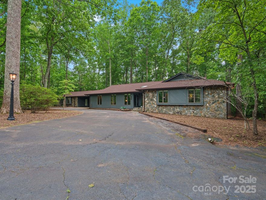 Escape the noise & embrace the quiet privacy of nature on this 9+ acre wooded property in the sought-after Clover School District. A long drive leads you through mature hardwoods to a welcoming home that offers a spacious layout w/4 BRs, large office & partial basement. Natural light fills the open living area w/a stunning great room featuring a wall of windows overlooking the outdoors. The kitchen w/it's perfect mix of charm & function, boasts white marble counters, large island, tons of cabinet storage, convection oven, gas stove & stainless farmhouse sink. The primary suite includes rare access to 2 full baths. If you need space for hobbies or guests you'll appreciate the 620 sq ft heated/cooled workshop w/half bath, ideal for a creative space or potential in-law suite. Plenty of parking w/attached carport, circular driveway & extra parking pads. New roof/gutters (2024), water heater (2021). If you love the outdoors, value privacy & are looking for room to breathe, this is the one!
