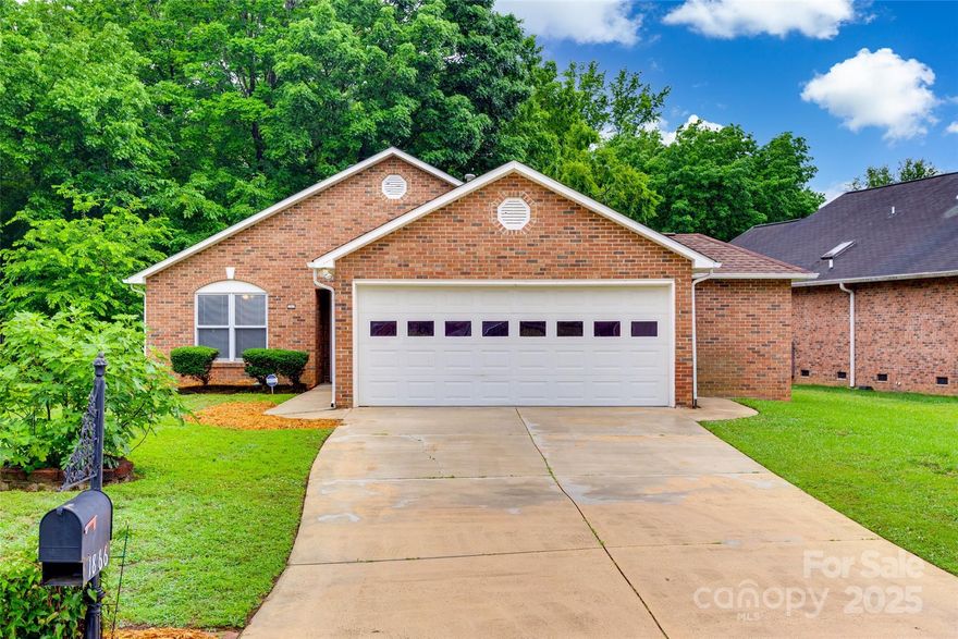 Welcome to Ravencroft! Tucked away at the end of a quiet Rock Hill street, this charming 1-story garden home offers an inviting open floor plan. Just off the entry, a flexible bedroom serves as a guest room or dedicated home office. The 2nd bathroom features a garden tub, walk-in shower, a skylight and full vanity. A cozy gas fireplace with mantle anchors the living space, while the kitchen offers great lighting, ample storage, and easy access to both dining areas. Enjoy your morning coffee on the private screened-in patio at the rear of the home. The spacious primary suite offers a large walk-in closet and an updated en suite with double vanity and skylight.  A 3rd bedroom and a mudroom/laundry room add convenience. Pella windows with inset blinds throughout. Backyard is fully fenced for privacy with a shed for storage. In addition, the 2-car garage has a large storage room for added flexibility. Close to shopping, dining, parks, and sports venues—this all brick home is ready for you!