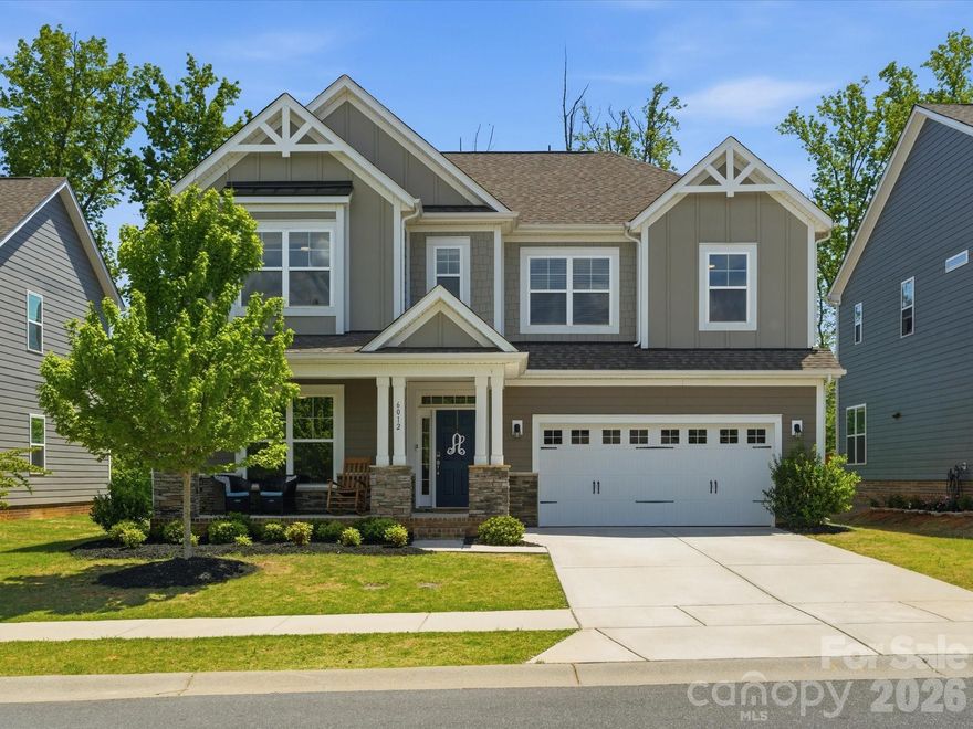 Located in Millbridge, one of Waxhaw’s most sought after, amenity rich community options known for tree lined streets and a strong neighborhood feel. This home offers an open floorplan, tons of natural light, and a private backyard backing to trees. The two story great room is bright and inviting, featuring statement lighting and a stacked stone fireplace. The white kitchen stands out with a gorgeous backsplash, gas cooktop, wall oven, walk in pantry, window sink and a spacious breakfast area that connects easily to the main living space. The main level includes a guest bedroom with full bath, ideal for visitors or a home office. Upstairs offers a versatile loft, two secondary bedrooms, and a primary suite with soaking tub and separate shower. Additional highlights include a rocking chair front porch, engineered hardwood floors, drop zone, new carpet and fenced backyard. Millbridge amenities include a lazy river pool with water slide, Jr. Olympic pool, fitness complex, walking trails, playground, open-air pavilions, and a community house with cafe and planned events, everything buyers are looking for in a true lifestyle community.