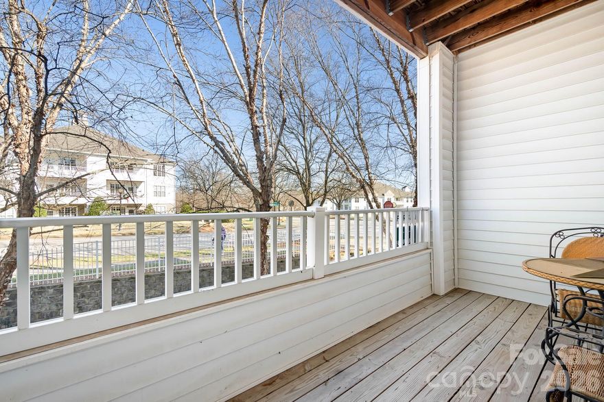 Attractive second floor condo ideally located in the heart of all the action. You will love its walkability to nearby restaurants. This building offers both elevator and stair access for added convenience. Updated kitchen with granite, white cabinetry, and a custom backsplash, fireplace, low maintenance flooring in the main living areas, faux wood blinds, tall 9 1/2 ft ceilings throughout, and carpet in bedrooms make this the ideal unit for everyday livability.  Open concept layout seamlessly connects the kitchen, dining, and living spaces, creating an inviting atmosphere. Kitchen is equipped with a microwave, dishwasher, and oven, with convenient access to the laundry area. Spacious primary bedroom includes a large en suite bathroom, window seating, and generous closet space. The second bedroom, positioned on the corner of the building, is filled with abundant natural light and easy access to the hall bath, making it ideal for guests, a home office, or additional living space. Outside you will enjoy views of the common area from the shaded balcony, perfect for relaxing outdoors. Community amenities include greenways, swimming pool, sports court, and a playground. That's not all, don't forget to take advantage of the close proximity to live entertainment venues, lake access, and outdoor recreation. The new hospital is nearby. Easy access to Huntersville, Cornelius, Mooresville & Charlotte. Don’t miss the opportunity to own this updated condo in an unbeatable location.