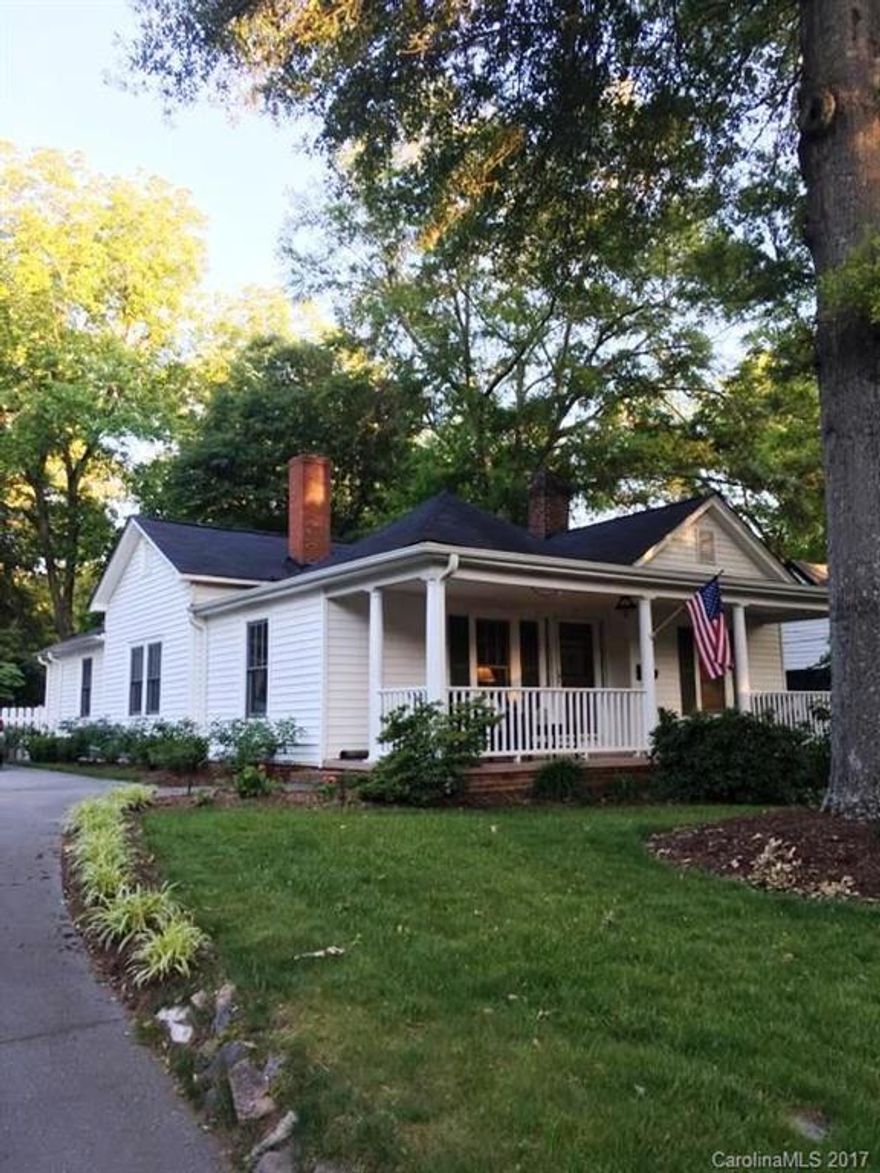 Amazing early 1900's cottage beautifully brought forward with great care to preserve it's history.  Electrical and plumbing have been updated, roof is less than 10 years, kitchen has been totally updated with the ceiling being raised, custom cabinetry, granite countertops, and fresh appliances.  Beautiful moldings and floors.  Large, covered front porch, fenced backyard with spacious deck.  40 x 40 workshop/storage building with electricity.  A true delight, easy walking distance to downtown.