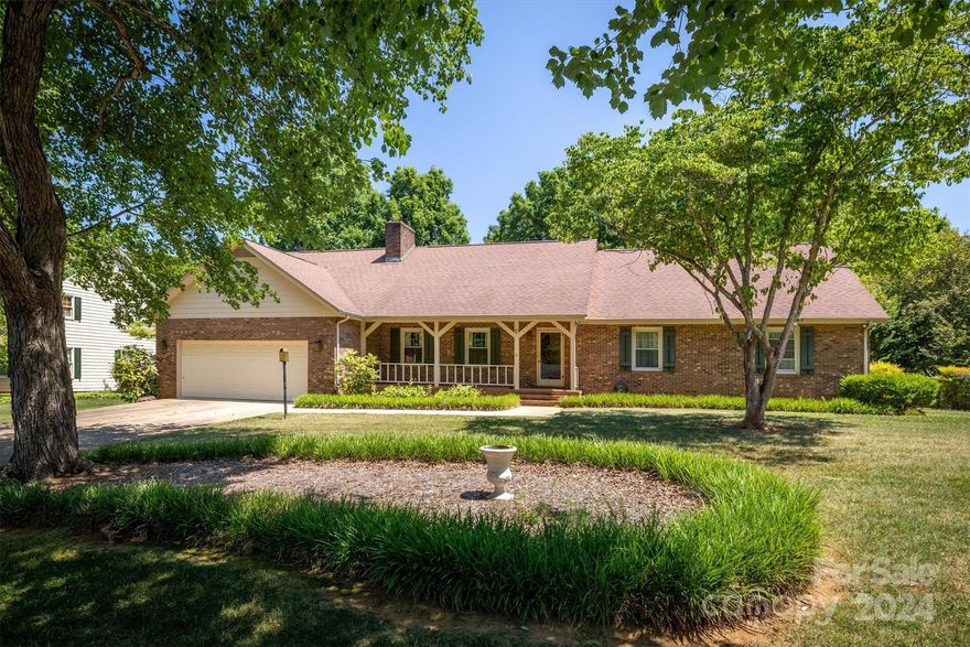 Gracious and Spacious Brick Ranch with welcoming covered porch.  Entry flows into inviting formal living room filled with natural light and brick wood burning fireplace.  Three bedrooms and three full bathrooms, gorgeous dining room all on main level.  Huge, finished room(s) over garage with skylight as well as unfinished attic storage. Nice level lot located in popular NW area in Hickory.