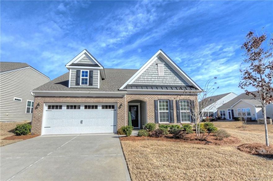 Inviting home in  Carolina Reserve neighborhood.  This beautiful ranch home w/ 3 BR has been very well maintained.  Features 3 bedrooms, 2 car garage, and a sunny Carolina room off the master bedroom. Spotless hardwood floors and carpet, dining room  with wainscoting, and a large great room (with fireplace!).  The sizeable kitchen has 42" dark walnut cabinets with an over-sized island counter.  Spacious  26' x 13' paver patio.  $64.00 monthly fee for lawn service.  Washer/dryer do not convey.