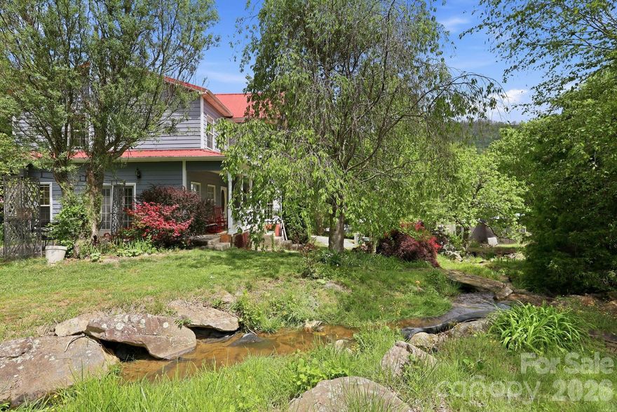 Step into this beautiful victorian-farmhouse blending timeless design with modern comfort.  Enjoy heated floors throughout, a breakfast nook, along with a dinning room on the main level.  Upstairs is the master bedroom with a sitting room/office off the bedroom.  Laundry room upstairs, so no need to carry laundry up and down steps. Stunning landscape with mature trees and a stream with small waterfalls just steps from the front porch. A homesteaders paradise with garden space along with a 30x30 shop with an outside wood boiler.  As a bonus, enjoy shared access to 491 acres- ideal for hiking, riding, or soaking in nature.  There is a pond with fish for catching.  You aren't going to want to miss this opportunity!!