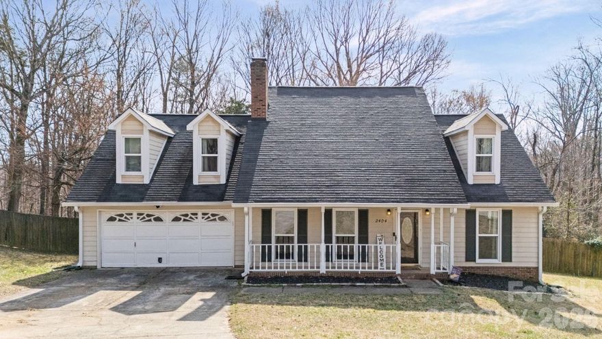 Welcome to 2404 Wildburne Court, a beautifully updated 3-bed, 2.5-bath single-family home nestled on a quiet cul-de-sac in the highly desirable Houston Farms subdivision of Charlotte. Built in 1990, this classic residence combines charm with thoughtful modern upgrades and offers 1985 sq ft of well-designed living space on a 0.26-acre level, wooded lot, perfect for both everyday living and entertaining. Inside, discover a spacious vaulted two-story great room centered around a wood-burning fireplace, creating an open and inviting atmosphere. The heart of the home is the modernized kitchen, featuring quartz countertops, painted cabinetry, stainless-steel appliances, and abundant storage. A convenient coffee bar, large pantry, and dedicated laundry room add to the functional layout. The primary bedroom on the main level enhances accessibility and comfort, while two additional upstairs bedrooms, a full bath, and a versatile loft space provide flexible living or work-from-home options. Outdoors, enjoy a covered rocking-chair front porch overlooking the cul-de-sac and a fenced, private backyard with a generous deck, ideal for barbecues, relaxing, or play. A large storage shed adds practicality for yard tools and outdoor gear. New gutter guard gutters installed in 2024. Additional highlights include an attached two-car garage, no HOA restrictions, and proximity to major highways, shopping, dining, and parks, combining convenience with peaceful neighborhood living.