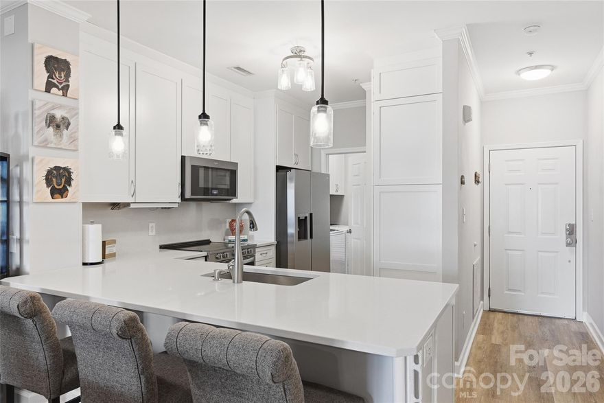 Dream Home on Lake Norman! This beautifully updated ground-floor condo offers easy living paired with a relaxed, resort-style lifestyle. The fully renovated kitchen (2020) features new cabinetry, quartz countertops, stainless steel appliances (Refrig & W/D 2023), and a built-in pantry cabinet with pull-out shelves—designed for both style and everyday function. A dedicated laundry room with cabinetry adds even more convenience. The inviting family room centers around a cozy fireplace with brand-new gas logs (2025), making it the perfect place to unwind or entertain. Step out to the covered back patio, ideal for grilling, hosting friends, or enjoying peaceful mornings—just steps away from the pool. The spacious primary suite feels like a private retreat with a large walk-through closet, while the secondary bedroom works beautifully as a guest room or home office. Recent updates include a Nest thermostat, new HVAC system (December 2025), kitchen pendant lights, outdoor ceiling fan (2023), and primary suite closet (December 2025) and primary crown molding (January 2026). The community offers an unbeatable lake lifestyle with a pool, clubhouse, fitness center, tennis courts, kayak and paddleboard launch area, and community dock. Water, and sewer are included in monthly HOA fee, making this home as practical as it is enjoyable. This is more than a condo—it’s your chance to live the Lake Norman dream.