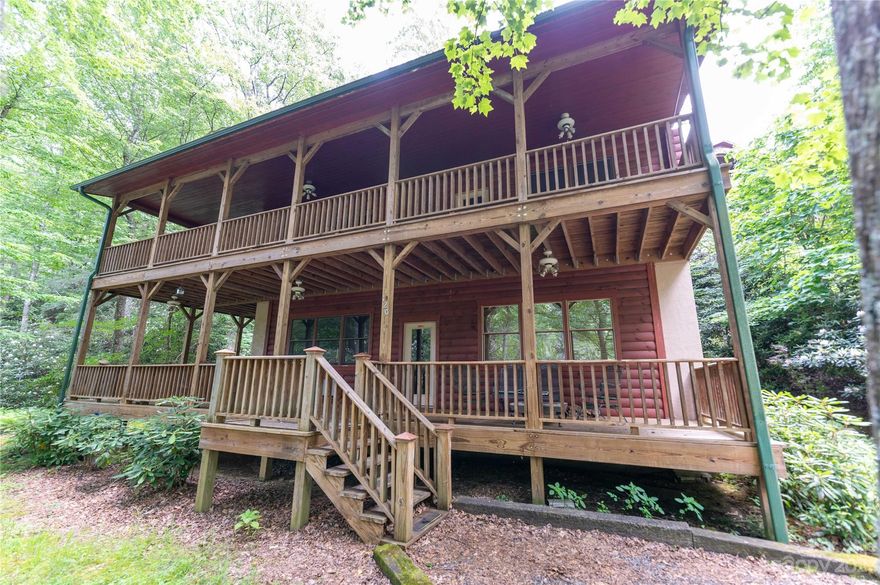 Beautiful three bedroom three bath home situated between two holes on the prestigious Mount Mitchell Golf Course, with the lovely sounds of the South Toe River coming from just beyond the tee boxes.  Solidly built log home, with half logs on the lower floor and full logs on the upper floor, and a foundation of 12 inch block that have all been individually poured.   Wrap around decks on both the main floor and the second floor, with views of the golf course. Perfect for seasonal escapes or year-round living. Great for entertainment or simply enjoying quiet evenings, soaking in the views from deck, sun room or living room. Curl up with a book in front of the striking fireplace on chilly evenings. Walk to the pristine South Toe River, the Golf Course and Pisgah National Forest with its trails and waterfalls. Only minutes to Blue Ridge Parkway, Burnsville Town Square, Little Switzerland, Spruce Pine or Marion. Less than an hour away from Asheville or Blowing Rock/Boone.