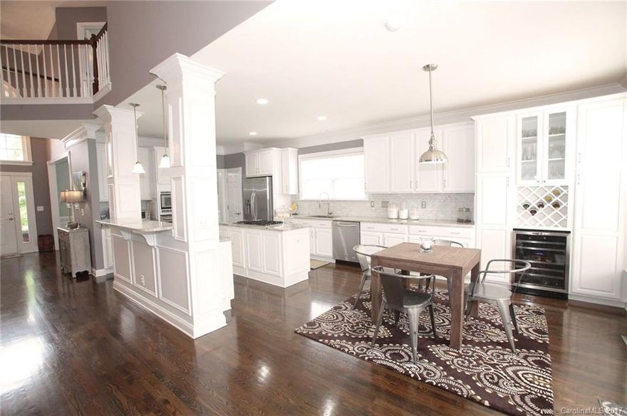 It's no secret what the shining star of this home is, THE KITCHEN! Complete with custom cabinetry, White Cashmere granite counter tops, wine fridge, gas cooktop & a beautiful herringbone back splash; your friends will adore being entertained in this space. Luxurious hardwoods throughout the main level. New tile and custom cabinets in laundry room as well as newly stained back deck and landscaping. Custom built-in entertainment center is focal point in the oversized loft on the 2nd level. NO HOA!