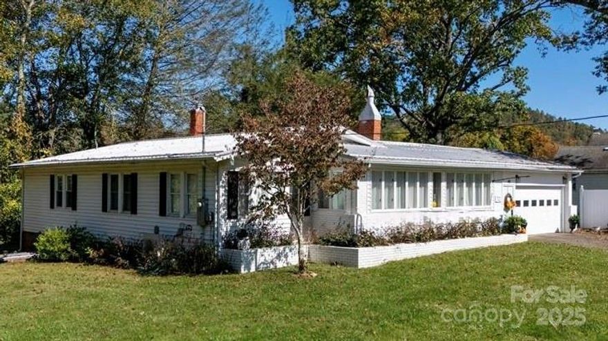 1940s Brick Ranch | 3 Beds | 2 Baths | Sunroom | Office | Large Finished Basement | 0.46 Level Acres | $459,000; Your Timeless Mountain Sanctuary Awaits – Where Vintage Charm Collides with Move-In-Ready Luxury; Nestled in the coveted historic English Woods neighborhood of Spruce Pine, this all-brick 1940s ranch radiates curb appeal on nearly ½ acre of level, park-like grounds framed by towering mature hardwoods and lush green lawns. From the moment you arrive the inviting front porch whispers “Welcome Home.” Step inside to sun-drenched interiors where original hardwood floors gleam underfoot and a cozy wood-burning fireplace enriches the expansive living room. Flow effortlessly into the chef-inspired kitchen boasting brand-new granite countertops, a deep farmhouse sink, stainless appliances and custom cabinetry—perfect for creating gourmet meals, morning coffee or hosting friends.  Elegant Dining room that opens directly to the newly rebuilt deck with integrated lighting—your private perch for al fresco dining or stargazing. Three generous bedrooms and two spa-like bathrooms (both fully remodeled just 3 years ago) offer comfort and style. Need a quiet escape? The dedicated home office with built-in shelving is ideal for remote work or creative pursuits. Craving sunshine year-round? The bright, four-season sunroom glistens with natural light; Downstairs, the magic multiplies. A sprawling finished basement with separate exterior entrance delivers endless flexibility: such as - Home theater, Gym or yoga studio, Guest suite, Teen hangout; Plus, massive unfinished storage space keeps everything organized. Outdoor living is a dream: Fully fenced backyard – safe for pets and perfect for weekend BBQs Level usable lawn – ready for gardens, firepit nights or play;  Oversized attached 2-car garage with workshop potential. Recent upgrades mean zero stress: New electrical panel & wiring; Modern HVAC system; Sump pump & moisture control; New deck, lighting & fencing; Location is everything: 5 minutes to charming downtown Spruce Pine (cafés, galleries, farmers market) 10 minutes to Blue Ridge Parkway & Grassy Creek Golf Course; Easy access to hiking, fishing, skiing and arts at Penland School This isn’t just a house—it’s your forever mountain retreat, your family legacy, your smart investment in the heart of the Blue Ridge.
MOVE-IN READY & PRICED TO SELL—Schedule your private tour TODAY – homes this special vanish fast. Reply now to claim 44 Hemlock Avenue before someone else does!
