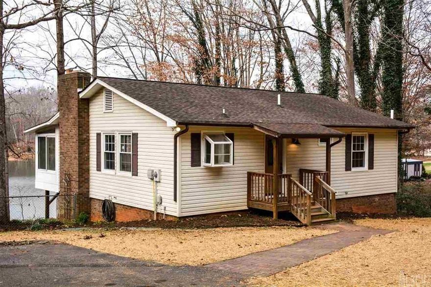 Located on picturesque Lake Norman, this two bedroom home is the ideal living space for those looking for a lakeside retreat, vacation getaway, or upgrading to a  newly refinished full-time residence.  Living lakeside has never been more comfortable! With a large, well lit dock and railed, wooden pathway, getting to and from your boat is safe and easy.  Entertaining from the comfort of your screened-in rear porch is perfectly paired with scenic, lakeside views.  Of course, the newly remodeled kitchen, equipped with stainless steel appliances & granite countertops, is just what you need to host social gatherings for family & friends.  Also included in recent renovations are refinished hardwood floors and carpet in every room, tile in both spacious bathrooms, & tasteful paint throughout.  The charming interior of this home pairs beautifully with the easy to maintain landscaping, gently sloping yard, and private boat launch.