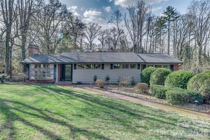 New Price! Beautiful Mid Century Modern home in well established Riverside area with 2025 UPDATES! Inviting Living Room boasts gas fireplace on main level with dining and eat in kitchen. 3 bedrooms on the main with a 4th or Office in the lower level. 3 full baths. Spacious daylight basement family room with gas fireplace, kitchenette and dining area. Updated basement with LVP Flooring, new carpet, trim, crown molding, new doors, and new lighting. Gas Bosch boiler installed 2023, Garage Door and system installed 2023, Dishwasher and disposal installed 2024, Ceiling fans installed 2024, Steel Door from laundry to garage installed 2025. Deck boards replaced in 2025. Adorable play space/pet space under the stairs. Fantastic lawn with gentle slope.  In town living yet tucked away so you don't feel you have participate when you need some down time on the deck!  Sunroom off Main Level Primary Bedroom. Desirable well maintained area. Walk to Downtown Morganton, or walk the Greenway. Close to I-40 and UNC Health Blue Ridge Hospital. Great Location!