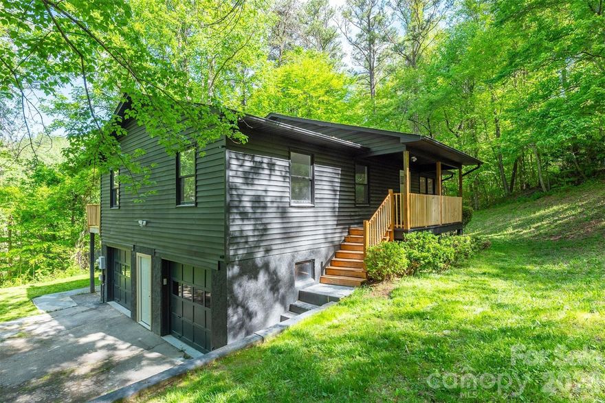Tucked away on a private 0.68-acre lot, this fully updated home offers the perfect blend of comfort, space, and convenience. With 3 bedrooms, 3 bathrooms, and nearly 2,000 square feet, the layout is both functional and inviting.

The main level features an open kitchen and living area with vaulted ceilings, creating a bright and spacious feel. The kitchen has been completely updated with new cabinetry, and all bathrooms and flooring throughout the home have been refreshed for a clean, modern look.

Downstairs, the finished basement adds flexibility with a second living area or TV room, a dedicated office, and additional storage space. A one-car garage plus extra storage gives you plenty of room for tools, gear, or hobbies.

Step outside to a brand new back deck that spans the entire length of the home, overlooking a private, wooded setting. The yard offers a great mix of usable grassy space and natural surroundings, complete with a play set already in place.

Located in a quiet Swannanoa community with city water and sewer, this home offers easy access to both Asheville and Black Mountain while still feeling tucked away.