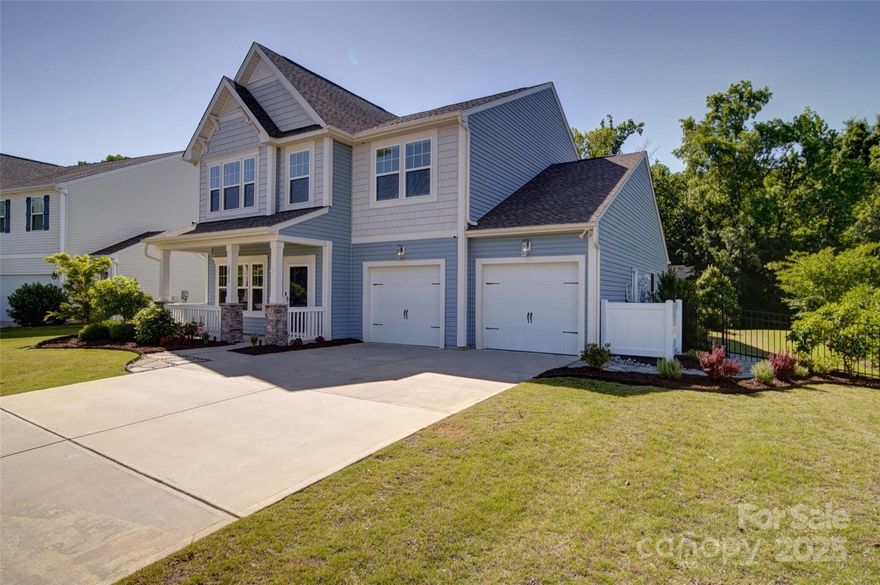 Amenities galore!!   Builder upgrades in kitchen and beautifully landscaped with wooded backyard and irrigation system. 4 BR/3.5 baths-a rare find with private bedroom with full bath on main floor.  Huge primary bedroom upstairs as well as a nice sized flex room in addition to 2 more bedrooms.  Enjoy an outdoor Fire pit, and completely paved patio with pergola and hot tub that's never been used by owner. Open floor plan features great room, kitchen island with seating, oven hood and upgraded backsplash, granite countertops; breakfast nook and butler's pantry.  Dining room is used as an office.  2-car garage floors are epoxy painted.  Tankless water heater and garage sink. Sunroom.  Second floor features large owners suite as well as a game room, spacious secondary bedrooms, and laundry room. Sun Valley Entertainment district with so much to offer for fun and entertainment. Seller offering $4,000 in closing costs.