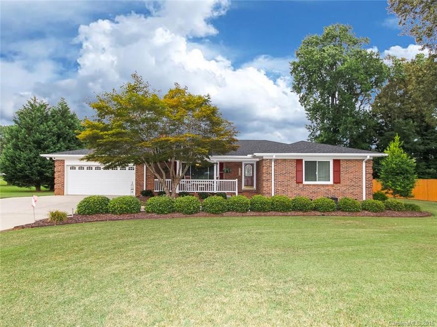 Charming full brick ranch! Many updates!Rocking chair front porch, gleaming hardwoods in foyer, living room & dining room. Great for entertaining! Spacious floor plan has modern kitchen, SS appliances & corian countertops.  Large master with heated tile floor in bath. Ceiling fans in all bedrooms. Sunroom leads to wrap-around deck & gazebo. Floored attic for storage.Wired outbuilding. New windows in 2013.New roof covering & dishwasher in 2014. Tankless water heater.Fridge conveys.NO HOA!