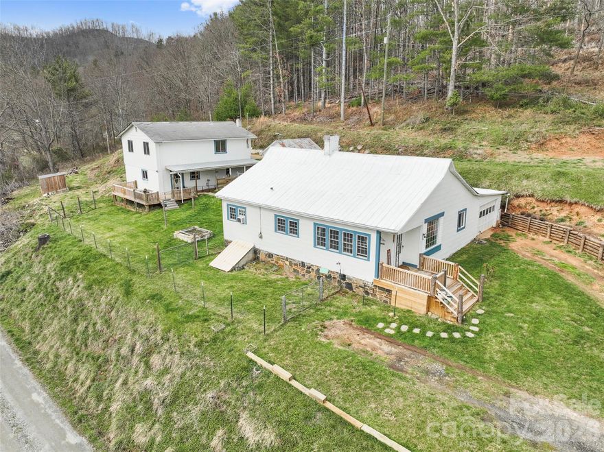 Discover a peaceful homestead retreat at 138 Robert Phillips Road on 10.5 acres of rolling hills & wooded beauty offer a quiet escape from the everyday. This Multi-Family property features a 1923 site-built home that radiates warmth & character, anchored by a cozy living room that's inviting throughout the seasons. The main level is thoughtfully designed for easy living, offering a functional kitchen and comfortable primary bedroom with large walk-in closet.  Natural light fills the interior & highlights the character of the home through the large picture windows which also offer year-round mountain & pastoral views. Adding incredible value & versatility to the property is a separate second living quarters, complete with its own kitchen, living area, and full bath. This space is ideal for those seeking a dedicated home office, creative studio, or comfortable guest accommodations. The outdoor amenities include an expansive deck for dining under the stars, a workshop for hobbyists & an additional outbuilding for storage. Nature enthusiasts will appreciate the property's frequent sightings of local wildlife among the trees. This acreage offers a rare combination of privacy & potential w/no restrictions allowing you to truly make the land your own. Whether you are relaxing on the front porch or exploring the hillside you will find a sense of serenity that only the Blue Ridge area can provide. This property is ready to welcome you home to a simpler, more connected way of life.