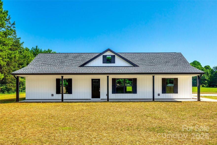 Welcome to your brand-new home! This well crafted 3BR, 2BA residence features a desirable split-bedroom floor plan that offers both privacy & practical living. The open-concept layout seamlessly connects the spacious living room, dining area, & kitchen—perfect for entertaining & everyday life. Enjoy stylish finishes throughout, including LVP flooring, granite countertops, & stainless steel appliances. The primary suite boasts a generous walk-in closet &  an en-suite bath with a walk-in shower. Two additional bedrooms & a full bath are located on the opposite side of the home, making it ideal for guests or a home office. Step outside to enjoy a covered front porch & a convenient 2-car carport, providing sheltered parking. A dedicated laundry room adds functionality to this well-thought-out home. Situated in a peaceful community with no HOA, this home blends comfort, convenience, & modern style in a beautiful setting. On 1.26 acres in Clover School District. A must see!