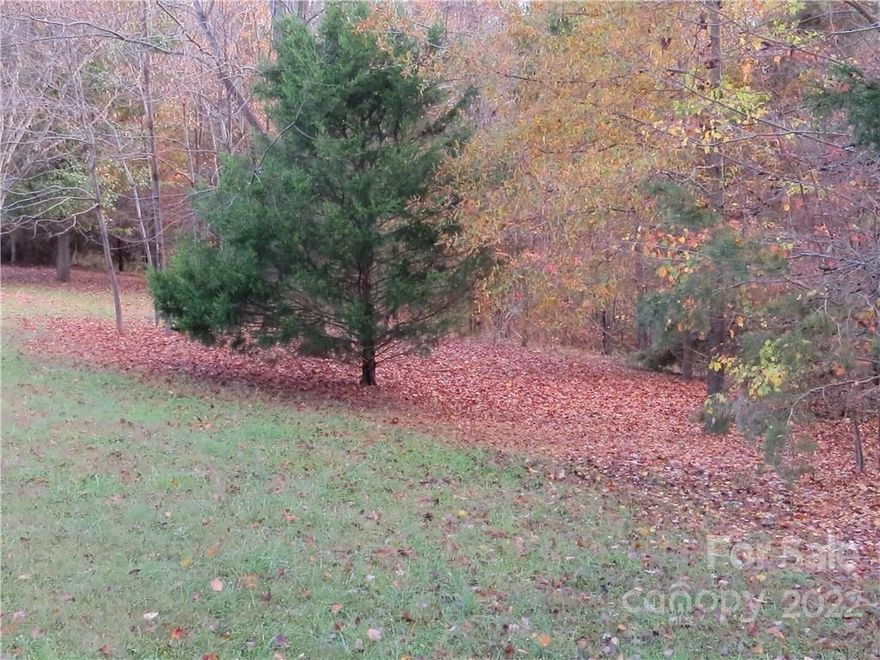 1.4 acres of Privacy!!  This has city water and sewer available.  No mobile homes, only modular or stick built homes allowed.  Popular North Iredell location.  Close to schools and perfect for country living!
DISCLOSURE:  Seller thinks the neighbor's building at 165 Cedarvale may be over the property line and encroaching on this property.