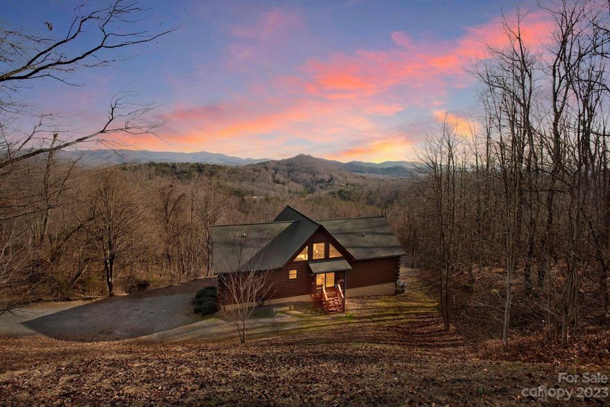 Nestled in nature, this log cabin offers breathtaking mountain views that will leave you captivated. The main living area boasts an open floor plan, beautiful woodwork and large windows that frame scenic views. There are DOUBLE primary bedrooms with en suites upstairs for ultimate comfort. While the lower level has a versatile layout featuring a bedroom, bathroom, bonus room, kitchenette, living space and an unfinished workshop or storage space. There is also separate entrance downstairs, offering potential for various uses. Enjoy TWO expansive decks perfect for outdoor relaxation and entertainment. This is a one-owner home, ensuring a history of care and attention. The property is located 2 minutes from Yogi Bear's Jellystone Park which features a water park, sports area, playgrounds and more. 20 mins to South Mountain State Park, 30 mins to Marion and directly between Asheville and Charlotte! Most furnishings convey.