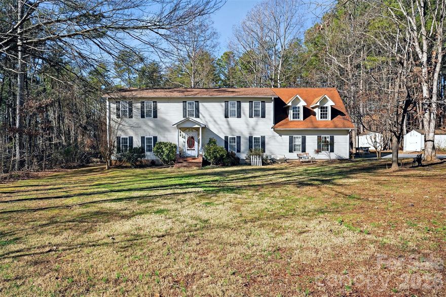 Beautiful 4 bedroom, 2.5 bathroom home that sits on over 4.5 acres of private land yet is located just a short drive to Columbus, Tryon and Landrum and is only 5 miles from the Tryon International Equestrian Center. This home features two levels with the main level featuring two separate living areas, one complete with a gas fireplace, a large kitchen, a great formal dining room, a 1/2 bath and access to a great rear deck that overlooks the private backyard. The upper level contains four spacious bedrooms complete with large closets in each of them. The upper level also contains two full bathrooms, including a large primary bathroom featuring separate tub and shower and a dual vanity. Above the attached two-car garage, you will find an addition completed in 2005 that contains a large bonus room that would be perfect for a variety of uses including another living space, bedroom or extra storage. The home also has two separate HVAC units for each level with one being replaced in 2025. A new roof was installed on the home in 2025 as well. Sitting on this acreage gives someone the ability to maintain their privacy with the wooded areas or they could choose to clear some of the wooded area to showcase the mountain views that are available. There is enough space where a small hobby farm could also be a possibility. Call to schedule your showing today!