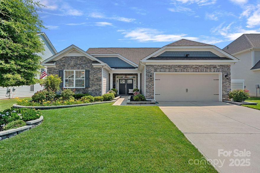 Beautifully landscaped 1.5 story home in Avondale. The open floor plan has 11’ ceilings on the main level and is filled with natural light. Spacious great room, with a gas fireplace and built-in shelving, flows into the dining area and the well-equipped kitchen. Featuring a gas cooktop, double ovens and quartz countertops, the kitchen also has a breakfast area and pantry. The primary bedroom has a tray ceiling and the ensuite bathroom has two sinks and a large shower. Two additional bedrooms share another full bathroom on the first floor. Crown molding and LVP floors throughout the main level living and bedroom areas. Upstairs is a 4th bedroom, 5th bedroom/bonus room and a full bathroom. Plantation shutters throughout the home. Excellent storage and custom shelving. Drop zone off the garage. A covered & extended stamped concrete overlooks the immaculate lawn and landscaped beds. Convenient Indian Land location and great neighborhood amenities!