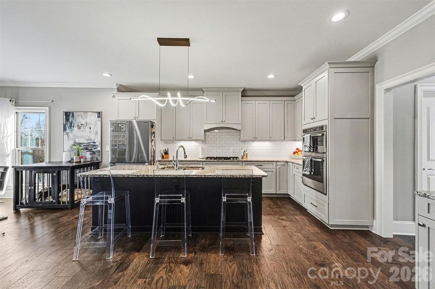 Experience refined living in sought-after Hidden Meadows, tucked away on a peaceful no-thruway street. This beautifully crafted 4-bedroom, 3.5-bath home showcases the quality and charm of a well-built design. Enjoy a semi-pro experience in the chef-inspired kitchen, fire up the grill on the deck, or explore the popular dining and entertainment options of Morrison Plantation and charming downtown Mooresville—just minutes away.
The home features stylish fixtures, a neutral color palette, abundant natural light, and gleaming hardwood floors throughout the main level. The spacious kitchen is designed for both function and flair, offering a gas cooktop, granite countertops, soft-close cabinetry, stainless steel appliances, a Butler’s pantry, and an attractive island layout that maximizes workspace and flexibility. The serene main-floor primary suite provides a comfortable retreat to start and end your day. Upstairs, three generously sized bedrooms with en suites offer privacy, ample closet space, and quiet comfort, along with a HUGE flex room ideal for a media space, playroom, or home office. Outdoor living shines with a breezy front porch, a composite deck, and a fabulous screened back porch overlooking a wooded backdrop. The fully fenced yard is ready for relaxation, play, or your own personalized vision. Additional highlights include a driveway with parking pad and a 3-car garage. Conveniently located less than 2 miles from lake access, this home perfectly blends luxury, comfort, and lifestyle.