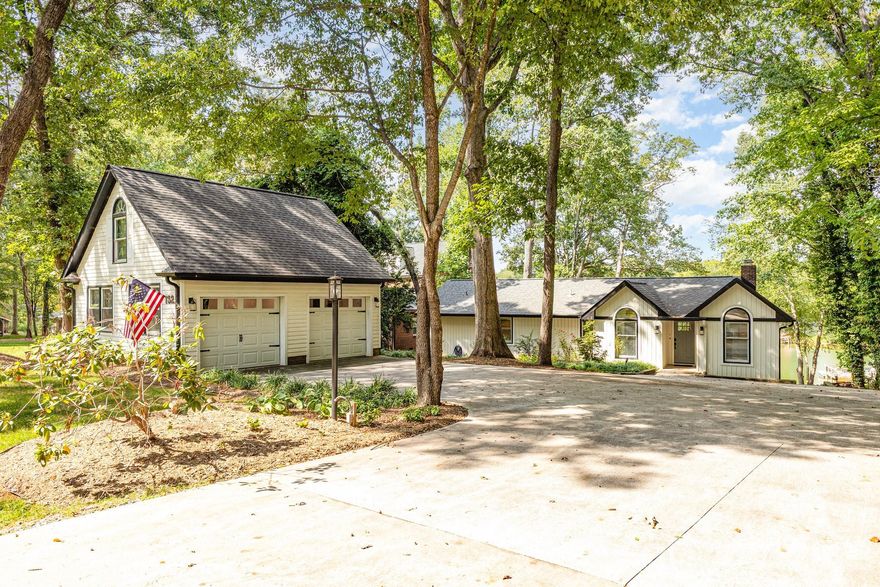 Dream waterfront home on Lake Norman in a desirable southern Mooresville location! .57 acre lot with 115 ft of direct waterfront and incredible year-round views of the lake. This fully furnished and extensively updated lake home offers true turnkey luxury and convenience. Open concept kitchen and living room with a gorgeous vaulted ceiling and a cozy gas log fireplace. 4 Bedrooms and 2 beautiful bathrooms along with a laundry room are all on the main level! An interior staircase leads to a walk out finished basement that is a bonus living space along with all the wonderful outdoor spaces. You'll love having your own personal dock that was built in 2022 and the 115 ft. of shoreline along with a beach area at the waters edge. You'll enjoy endless hours on the water. This deep and wide cove offers quick access for boating, skiing, fishing or just floating. The outdoor firepit and deck spaces are outfitted with heavy duty composite seating to enjoy the tranquil water views. There's a large 588 sq ft detached 2 car garage that's conditioned with a mini split and currently serves as a game room but could easily be converted back to a garage.  Fantastic location gives you quick access to I-77, close to Lowes Corporate, everything Mooresville and only 30 min from Charlotte Douglas airport. Low Iredell County taxes. Home was completely remodeled with all new systems and full permitting in 2022. New roof 2025, HVAC 2022, Well 2022, Dock 2022, Septic tank 2023. With no HOA restrictions, the possibilities are endless! Short term rentals allowed. It's currently a successful short term rental and would also make a great part time vacation home or full time waterfront residence within an easy commute to uptown Charlotte.