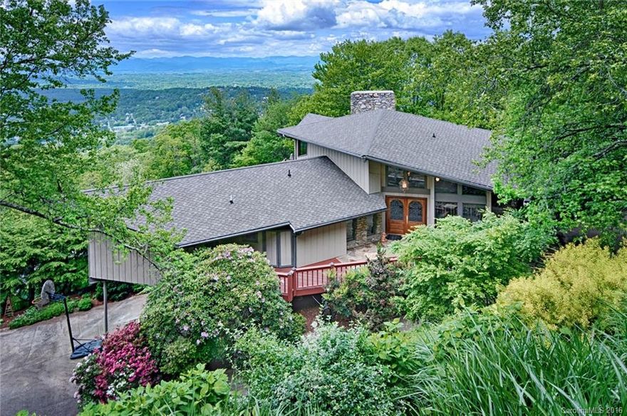 Outstanding style & views less than three miles from downtown Asheville. This Robert Griffin design flows with the land to provide awe inspiring vistas. Architectural details and style abound. Large wrap-around deck provides ample space for entertaining and a zen-like gazebo beside a waterfall offers a relaxing getaway. Chef-inspired kitchen with custom cabinets & updated appliances. Lower level includes a sauna, hot tub, and a family room, made from re-claimed barn wood, with a bar & fireplace.