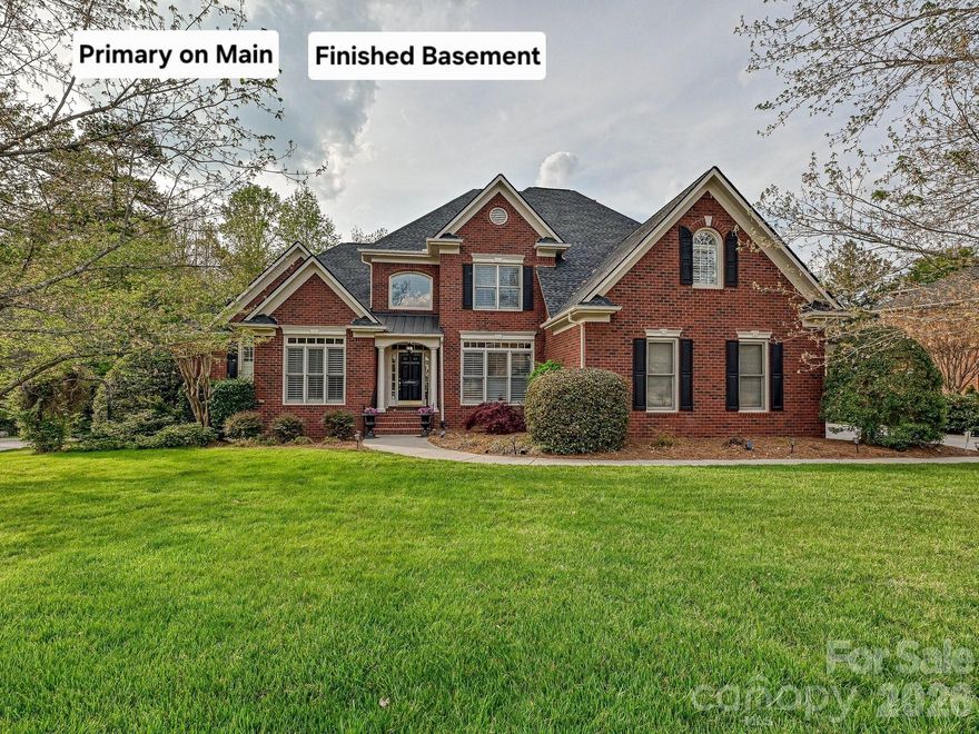 Spectacular brick home w Primary BR on main level and a finished basement on a prime wooded and private lot! Located in John Wieland's premier neighborhood Weddington Chase! HW floors most of main level, formals plus a main level office (LR could be a second office if needed), amazing 2 story GR w curved rear wall of windows plus built-ins and custom fireplace surround and trim, primary BR w trey ceiling, dual walk-in closets and BA w vaulted ceiling, tile floor, whirlpool tub and separate shower, gorgeous kitchen w upgraded cabinetry, custom island w wood countertop, bay window breakfast nook, and beautiful  keeping room w 2 story stone FP and wood beams! Central staircase with wrought iron balusters, 3 large BRs upstairs (one is oversized and could be a bonus/media room), all with direct BA access. Large laundry room main level w utility sink and base and upper cabinets. Stunning basement reminds you of a mountain retreat! Cedar plank siding, 2nd kitchen w island and huge dining area, tile floors, bonus/media room with wood beams, custom built-ins and stone FP, 2 BRs (one has a stone FP!), workout room and flex room! Also, lots of unfinished storage space! Spacious 3 car GA w storage cabinets and workshop area! Beautiful backyard w covered patio plus outdoor FP with large stamped concrete patio. There's even a treehouse! Plenty of room for a pool. Weddington Chase features half acre+ lots, full brick homes, top rated schools and a state-of-the-art amenity center w clubhouse and fitness center, tennis, basketball and volleyball courts, playground, fishing pond and walking trails! Truly a special home in a special neighborhood!