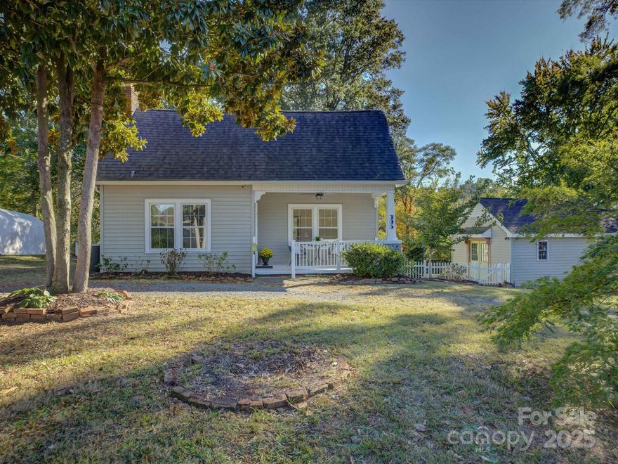 Discover this storybook bungalow where timeless charm meets smart design. Perfectly situated in the heart of Fort Mill’s vibrant downtown, this home offers easy access to local restaurants, shops, and the park—making every day feel like a getaway. Head inside to find beadboard detailing throughout, adding warmth and character, and a tile-surround fireplace that creates a cozy focal point for relaxing evenings. The floor plan maximizes every inch, combining historic charm with modern livability. Out back, enjoy a large, private yard—ideal for gardening, gatherings, or simply unwinding. A spacious storage shed offers endless possibilities, whether for hobbies, a workshop, or extra storage. Don’t miss the chance to make it yours!