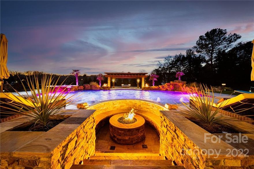 Artfully crafted with sophisticated finishes and design, this one-of-a-kind custom home features an easy living floor plan that accommodates everyday life and entertainment on a grand scale in the backyard haven. The open layout features an elegant foyer, formal dining room, spacious dual office with built-ins, a superbly finished kitchen with two islands, chef-quality appliances, an abundance of cabinets, overlooking the fireside great room. Generous primary suite offers a sitting area, fireplace, and lavish bath with double vanities, soaking tub, and walk-in shower. The enviable features of the spectacular backyard include a heated salt-water pool with grotto, waterfalls, bubblers, spa, fire bowls, multiple sun shelves, and four swim up bar stools. A sunken fire pit, covered terrace, travertine pool deck, two grilling stations, pergola, 5-hole putting green, fenced yard, mature landscaping, and lighting throughout, complete this oasis. No detail was overlooked in this exquisite home!