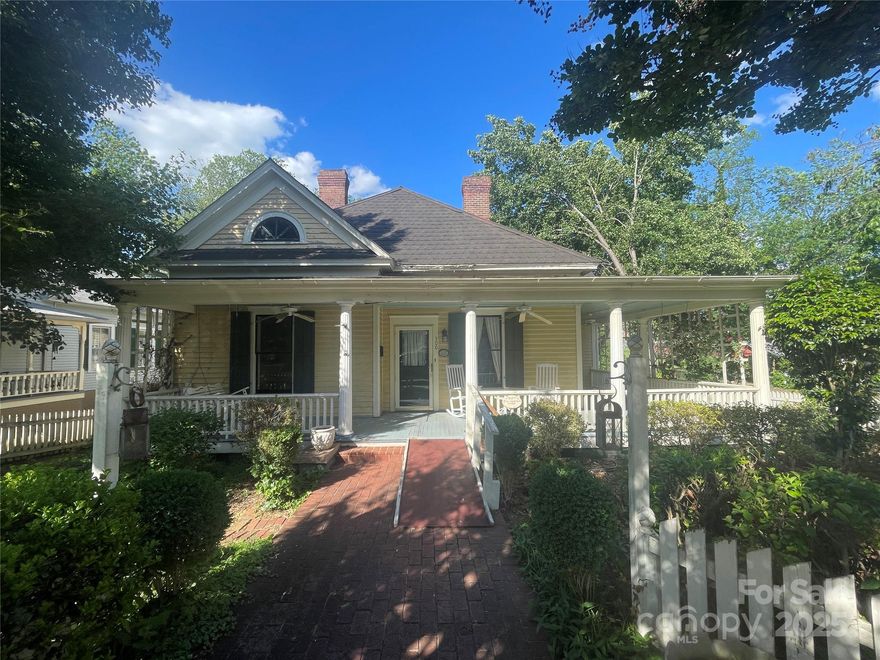 Nestled in the Ellis Street Graded School Historic District, the T.J. Anderson House at 500 W. Council Street sits in the heart of Historic Salisbury, NC. Built circa 1912, this architectural treasure showcases the Queen Anne style with its soaring ceilings, original moldings, mantels, wainscoting, hardwood floors, period doors, and hardware. Thoughtfully restored in the 1990s to reflect its original charm, the home features classic clapboard siding, louvered shutters, decorative lunettes in the gables, and a stately porch supported by fluted Tuscan columns with matchstick balusters extending along the front and eastern wing. A tall hipped roof with pressed metal shingles crowns the home. Positioned on a corner lot with mature landscaping, the property includes a spacious back deck overlooking a generous brick patio, all enclosed by a combination of picket and wooden fencing. Located within walking distance of Bell Tower Green Park, downtown shopping, restaurants, and three theaters, this distinguished historic home is ready to welcome new owners to carry on its legacy. Historic district restrictive covenants apply.
