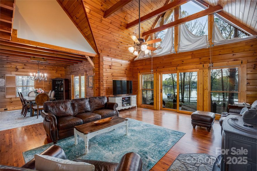 This true log cabin on the shores of Lake Wateree will make all your dreams come true. A spacious open great room with vaulted ceilings, gorgeous Australian cypress wood floors and wall of windows beckon you to relax by the Jotul wood stove and its comforting fires.The updated kitchen has stunning soap stone counters, modern painted cabinets and stylish upgraded appliances.The primary bedroom on the main level enjoys access to the deck where you're sure to enjoy sipping your morning coffee while watching the many birds that live here. Upstairs are two spacious guest rooms with an updated bath featuring a stunning italian tiled shower. The entire cabin has new fixtures including crystal chandeliers for a pop of elegance. Outside, you'll find a shed with party fridge, wood shed, a huge slate tile patio sure to be the best entertaining spot, and landscaping that leads to a sandy beach and your own private dock. The property boasts 2 acres and is the perfect cabin in the woods!