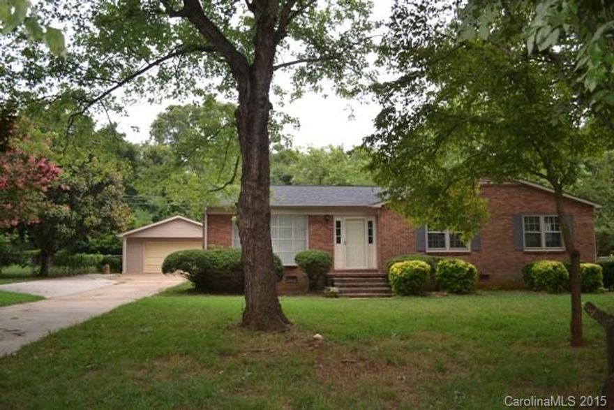 Mostly brick ranch home has newer roof, gas pack and water heater.  Large living room with beautiful floor to ceiling window, great room has fireplace and a solid oak mantle, spacious kitchen with gas range.  Enjoy morning coffee in the large sun room.  There is also a detached double garage with a work bench and a green house that has water.  Tons of potential in this great home which is located near Winthrop University!