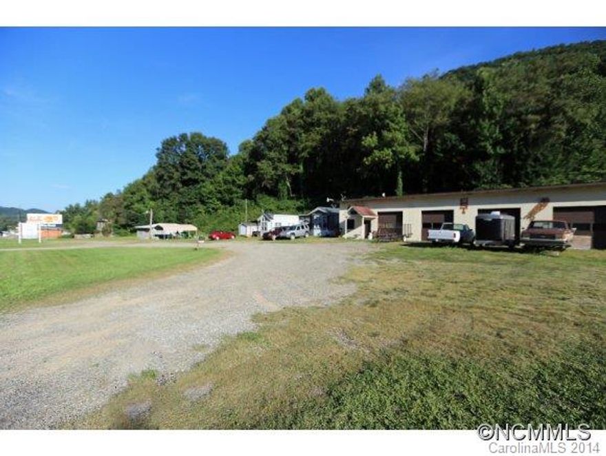 Don't miss this rare opportunity:  Fantastic 2+ acres with over 400+ feet of road frontage with city water and sewer with over 3600 sq ft of warehouse with three bay garage doors, and income from rented billboards. Many opportunities await, includes PIN# 8607-50-7015