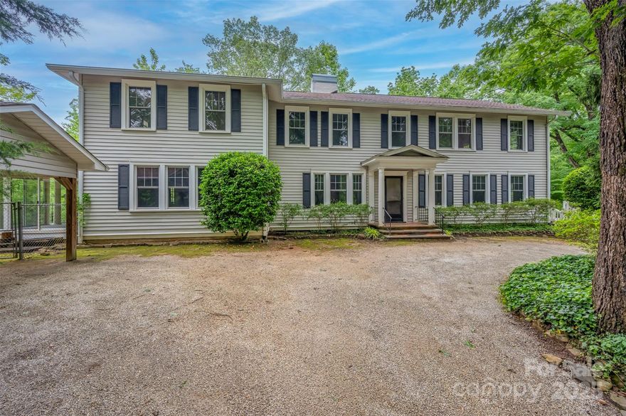 New year, new price! Discover the potential of this 1930 classic, set in a peaceful setting just outside the heart of Tryon. With its generous scale, timeless architecture, and rare acreage, this home offers a unique opportunity to restore and reimagine a piece of history. Step inside and you’ll find spaces designed for gathering and entertaining: a welcoming parlor, an expansive great room with soaring ceilings and a stately fireplace, and a spacious dining room ideal for hosting. Original features like rich wood paneling, dentil molding, hardwood details, and four fireplaces throughout showcase the home’s enduring character.  The layout includes five bedrooms, a grand primary suite, a bright sunroom, and a large unfinished basement offering over 500 square feet for storage, hobbies, or work space. Outdoors, enjoy the peace of true privacy — over six wooded acres create a natural buffer from the outside world while remaining minutes from town and interstates. A multi-car carport with storage and a whole-house generator add convenience and peace of mind. This property is ready for its next chapter—whether you envision a full restoration, a modern transformation, or simply bringing back its 1930s charm. With space, privacy, and character rarely found in one package, it’s a chance to create something truly special in a coveted location.
