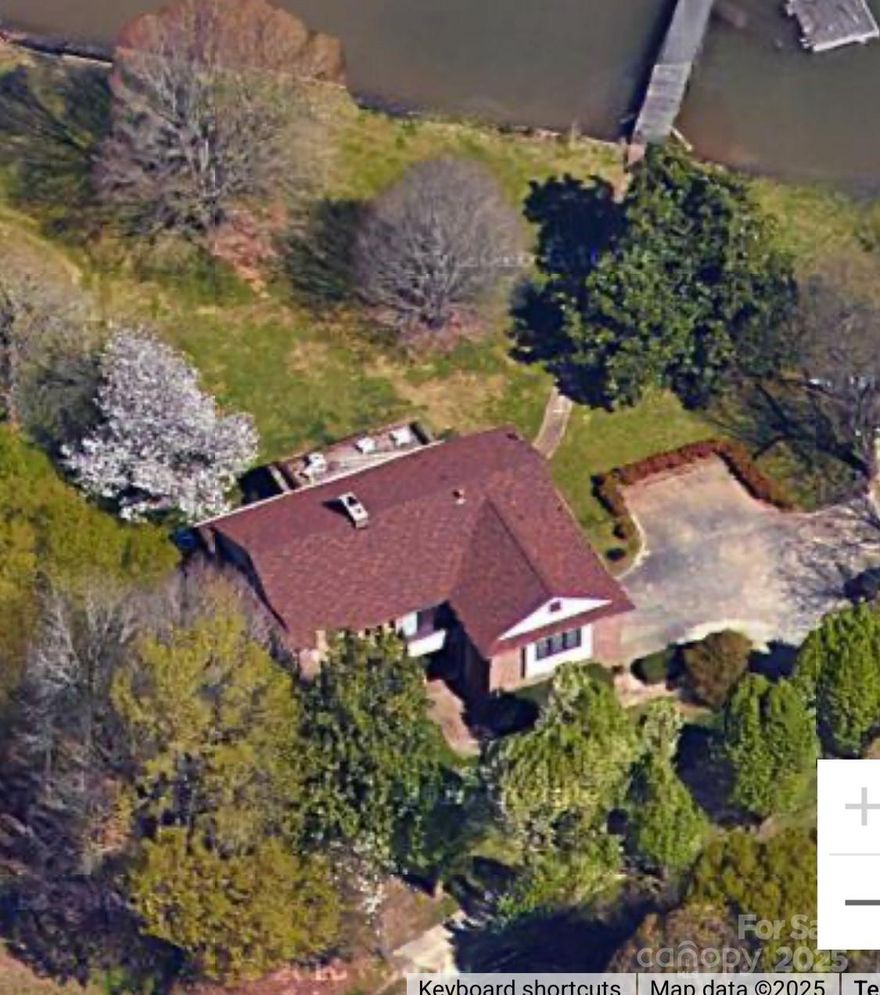 Welcome Home to this rare 1.23 acre lot, 350+' of shoreline, beautiful sunsets and panoramic views of the main channel on Lake Wylie!  Step inside this 1975 custom built estate and envision the possibilities. Huge kitchen with FP, and a wall of windows that flows to a light filled sunroom with expansive views in 3 directions. Home features 3 spacious bedrooms with ensuite full baths providing privacy and comfort for owner and guests, all boasts lake views! Primary bedroom has cozy brick FP.  Multiple closets offer tons of storage.  The inviting sunken great room has fireplace and built-in bar. Open staircase and expansive windows invite nature and plenty of light indoors. A hidden gem on Lake Wylie with dock, boat house, serene sunrises, and awesome sunsets offers lake living at its best. This unique property is more than just a home, it has natural beauty, functional living space, and room for  personalization. Your future oasis awaits. 12 min. to I-77, 30 min. to Chlt.