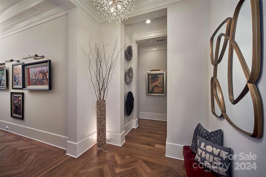 Stunning 3BR/3.5BA PENTHOUSE featured in Charlotte Magazine. Custom designed to curate your footprint without sacrificing quality, elevator opens to 3000+sf home with New York pre-war vibe, herringbone walnut floors, sweeping views of sunsets over neighboring treetops, 12-14' ceilings, 8' x 2' gas FP, w/open plan to the ultimate Chef's kitchen. Bespoke cabinetry built to 10' with rolling custom library ladder. 48" Wolf gas range, w/ griddle, grille, pot filler + sep steam oven. 2 Fisher/Paykel DWs, undercounter fridge, ice maker & micro. 10' long Quartzite waterfall island seats 8-10. Custom temp controlled wine wall. Covered lanai with electric grille, beverage fridge & power shades overlooks resort style pool. Primary has marble en suite, boutique style closet. 2 add'l en suite BRs, sep Office, laundry & powder. PRIVATE 2 car garage w/EV charger! All tile floors are heated. Control4 Auto, Toto Toilets, on-site storage, gym, CH, Pickleball, dog park, fire pit. *Pls see virtual tour.