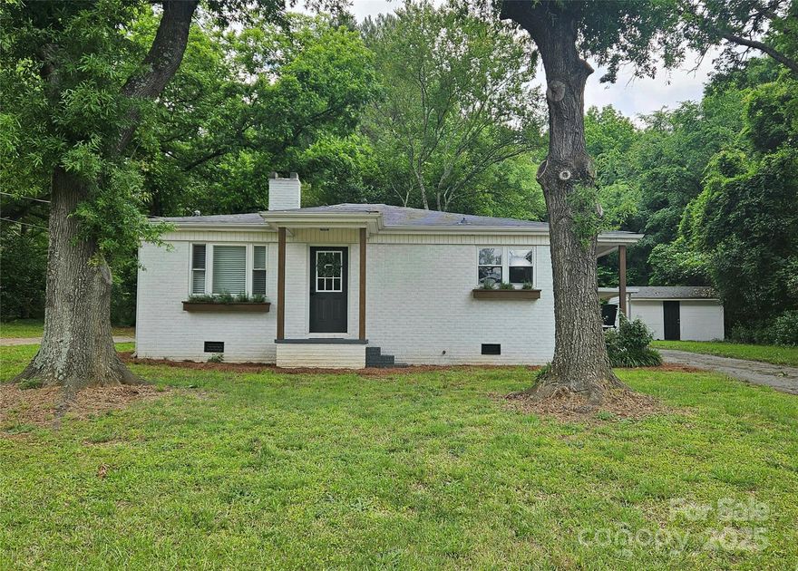 If you’re looking for character, charm, and low maintenance, this one checks all the boxes. Built in 1957, this full brick home has had only two owners & has been beautifully updated. Inside, you'll find an open split floor plan w/custom stained thin slate wood floors throughout most of the home, offering a unique look you don’t see often. The kitchen & bathroom are completely new w/granite countertops & stylish tile finishes that give a fresh, modern touch. Outside, there’s a detached 190 sq' block building w/power and a concrete floor – perfect for a workshop, hobby space or storage. There’s also a 10'x7.5' shed off the back. The best part? This property has commercial potential, so it could be a great fit for a small business or someone looking to run a shop or office from home. It has a two entrance circular asphalt driveway and plenty of room on the 1.65 acres to add an additional building, warehouse and parking. It’s the perfect mix of old-school quality and new updates!