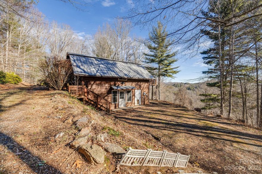 Seller VERY motivated!!! Indulge in the rustic allure of this barn-style cabin, situated on 15 unrestricted acres of enchanting wooded landscape, only 10-minutes from Burnsville. The circular driveway provides convenient drive-up access to both stories of this versatile home. With 4 beds & 2 baths evenly distributed across the two levels, envision the potential for creating two distinct homes within this unique structure. In addition to the home, this property features a chicken coop, multiple sheds with electric, a barn with 2 electric-ready stalls, an all-purpose "cabin", and more. Immerse yourself in the natural beauty surrounding the property, including deer, turkey, rabbits, & more. Uncover the fixer-upper potential, where steel beams ensure a sturdy foundation. The porches await your personal touch where you can relish the year-round mountain views. Embrace the opportunity to transform this property, seamlessly blending nature's charm with comfortable living.