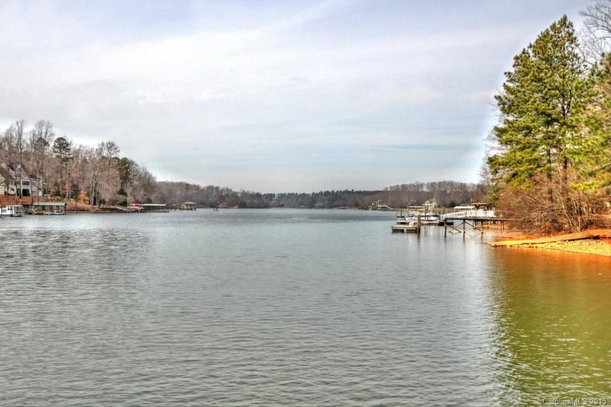 Over 200 feet of waterfront make the view from your screened in porch absolutely amazing.
Gently sloping lot with room for additions or building. Great weekend get away with a covered pier and jet ski lift to convey. 300+ foot well. Very quaint and conveniently located off of Brawley School Rd. Close to shopping, restaurants and all that Lake Norman has to offer. Boat lift does not convey. This property is being sold AS-IS. A must see if you are looking for a great waterfront property.