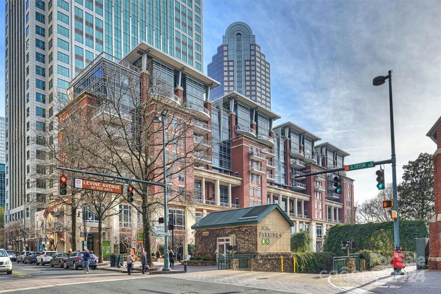 Welcome to luxury living in Charlotte's premier condominium complex! This exquisite residence boasts a custom renovation that is sure to impress! Featuring a fabulous open floor plan with split bedroom design, this stunning home offers a gourmet kitchen/living room/dining area with floor-to-ceiling views, a split bedroom floor plan, and  office nook.

The gourmet kitchen boasts quartz counters, Jenn Air appliances, and a wine fridge.  
The wall fireplace sets the tone for elegance and warmth. Luxury tile flooring flows throughout the home.
Retreat to the spa-like bath, where a rain shower and custom cabinetry await!

Enjoy the extended patio with covered and uncovered outdoor space to enjoy panoramic city views.

Additional features include a separate storage closet and 2 designated parking spaces. Located just steps from museums, the Panthers stadium, Truist Field, Spectrum Center, and an array of dining options, this is a rare opportunity to experience the best urban living!