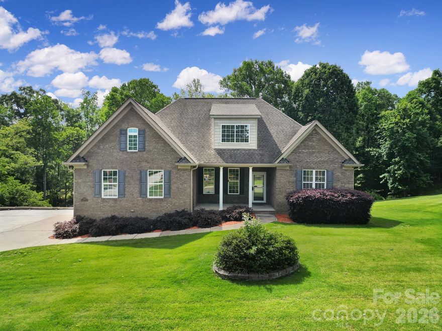 Charming brick home with a basement overlooking a beautifully landscaped backyard and serene pond setting. The extended driveway leads to a side-load 2-car garage, plus an additional detached 2-car garage offering exceptional parking, storage, or workshop space. Enjoy year-round views from the expansive sunroom on the main level or relax on the screened porch below.

The spacious kitchen overlooks the inviting living room with soaring vaulted ceilings, creating an open and airy feel perfect for everyday living and entertaining. Cozy fireplaces on both the main and basement levels add warmth and charm throughout the home. Generously sized secondary bedrooms provide plenty of space for family and guests.

The primary suite features a large walk-in closet and a luxurious ensuite bath complete with dual vanities and a soaking tub. Ample storage abounds throughout the home, including walk-in attic storage and extensive basement storage space. This exceptional property offers the perfect blend of comfort, functionality, and picturesque outdoor living.