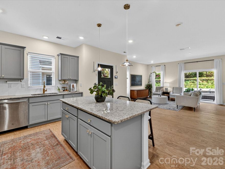 Immaculate 3-bedroom end unit with a rare 2-car garage and thoughtful updates throughout! Built in 2022, this townhome features engineered hardwoods and an open floorplan on the main level, creating a bright and inviting living space. The kitchen showcases shaker style cabinets, a subway tile backsplash, gas range, pantry and a spacious island with at-counter seating that flows seamlessly into the living and breakfast areas. Half bath on main. Upstairs, the primary suite offers a tray ceiling, custom walk-in closet, glass shower, and dual sink vanity. Bedroom 2 also features a custom closet and shares a hall bath with a dual sink vanity. A loft provides versatile additional living space, and the laundry room is conveniently located upstairs. Enjoy a private patio backing up to trees and an unbeatable location near downtown Matthews, Crooked Creek Park, Austin Village Shopping Center, and Sun Valley Commons. HOA amenities include playground. See attachments for the full list of upgrades.