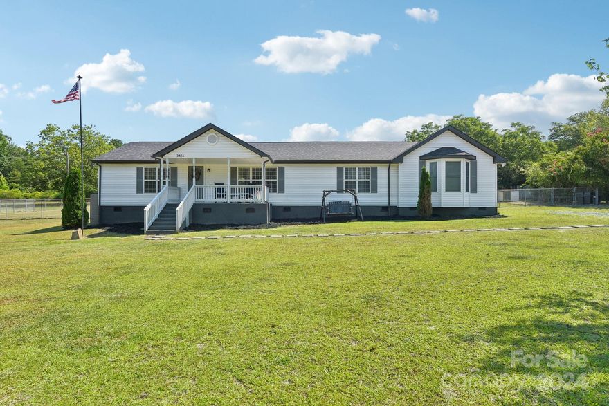 Welcome to this beautiful, remodeled home on almost 2 acres. Fabulous location within a 5 minute drive to I-77. Great kitchen with granite countertops, white cabinets and new stainless steel appliances. Barnwood LVP throughout the home - no carpet. Split bedroom plan with large primary suite which has a large closet and flex space. Primary bath has granite dual vanity, oversized tub and large tiled walk in shower. Enjoy the outdoors on the large deck or by the beautiful fire pit. Several outbuildings (wired with dedicated breaker), chicken coop with a water line and a large section of the yard is fenced to complete the backyard retreat. The yard does go beyond the fence, there are stakes marking the lot boundary. 
Close to the new Kettlesong mixed use development (currently delayed) that should bring city water and sewer to the area.