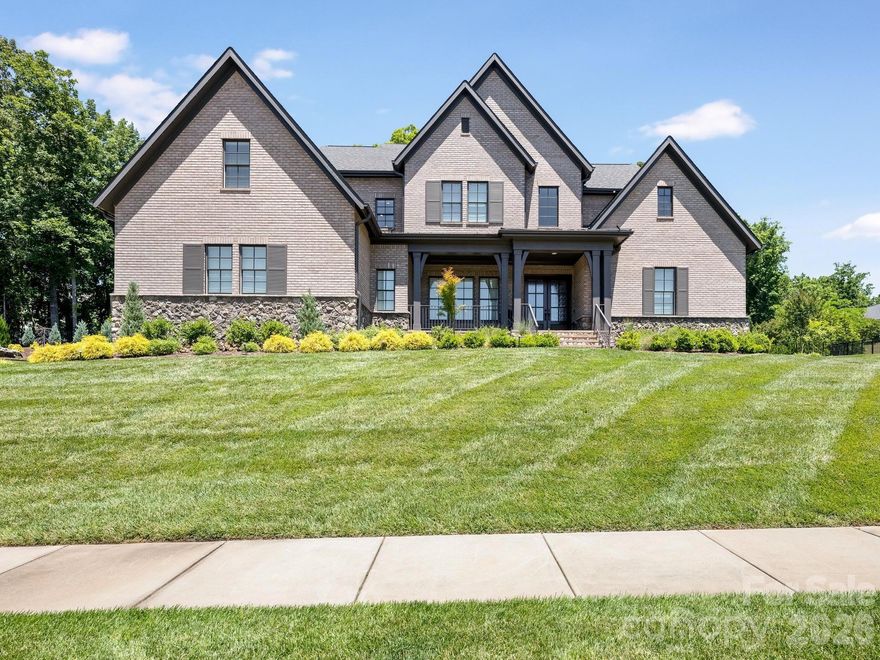 This exceptional home delivers architectural excellence, fine craftsmanship, and refined luxury living that discerning homeowners expect from an Arthur Rutenberg Masterpiece. Every room, every detail, and every finish in this 4-bedroom, 4.5-bath home has been thoughtfully crafted with premium touches for both beauty and function.
From the moment you enter, you’ll experience the difference that full custom workmanship makes. A covered front porch opens into a striking two-story foyer featuring a graceful curved wraparound staircase, creating an inviting and undeniably grand entrance. The open-concept floor plan flows effortlessly from the formal dining room through the great room to the chef’s kitchen and home office, providing an elegant backdrop for both everyday living and special gatherings.
The gourmet chef’s kitchen features premium appliances, a gas cooktop, crisp white cabinetry with a dramatic black stone island, abundant counter space, and a walk-in pantry. This is where culinary dreams meet everyday functionality. A dedicated wet bar with a wine refrigerator and ice maker stands ready for entertaining. Coffered ceilings, custom millwork, premium finishes, a convenient main-level powder bath, and laundry room complete the thoughtful design.
The owner’s suite is privately situated on the main level for ultimate convenience and features spa-like luxury with dual vanities, a soaking tub, a walk-in shower, and a custom master closet appointed with well-organized furnishings that rival a luxury boutique. Upstairs, three generously appointed bedrooms each offer en-suite bathrooms and walk-in closets, providing both versatility and privacy. A spacious upstairs club room offers flexibility as a recreation space, secondary office, or guest suite.
This is a modern entertainer’s dream, with expansive, naturally light-filled living spaces soaring to tall tray and vaulted ceilings accented by architectural millwork details throughout. A gas fireplace in the great room creates a warm focal point for gatherings, while the sliding glass wall system seamlessly extends the main living area to the generous covered back porch. A built-in outdoor fireplace and the exceptionally private, fully fenced grounds are perfect for open-air entertaining.
In-ground irrigation keeps the professional landscaping pristine year-round. Built in 2020 on a coveted 0.89-acre cul-de-sac lot in the prestigious Stevens Grove community, this home combines quiet suburban charm with proximity to excellent schools, dining, and shopping. For more information or to arrange a private showing of this exceptional home, contact the listing agent today.