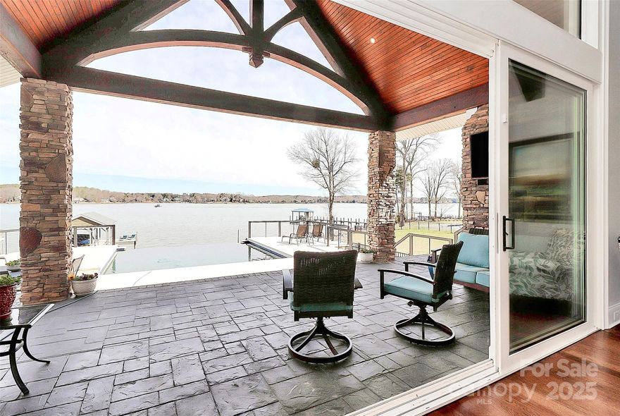 Beautiful, waterfront home. Enjoy the lake life in this 4534 sq ft home located on Lake Norman's main channel with stunning long range views from nearly every room. Beautiful custom real timber beams greet you as you enter and extend onto the covered porch. This home is made for entertaining with sliding doors located in the living area, office and primary bedroom that open directly to the porch and pool deck, complete with spa and infinity pool. Upgrades throughout in this builder's personal home. No HOA fees in this quiet community. 3 BR, 3 1/2 bath with office, flex areas and large loft area upstairs. Enjoy the functionality of the beautiful custom primary closet complete with vanity, window seat and large island.  Over 460 square feet of unfinished area above the garage for future expansion or storage. The large 3 car garage has hard-coated flooring, and a large parking area for a multitude of guests. Private dock with boat lift and a private boat ramp located on the property.